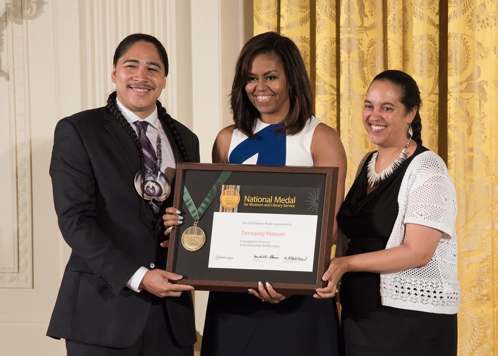 2016: Narragansett community member Christian Hopkin and Tomaquag Museum Director Lorén Spears accept the National Medal for Museum and Library Service from First Lady Michelle Obama.