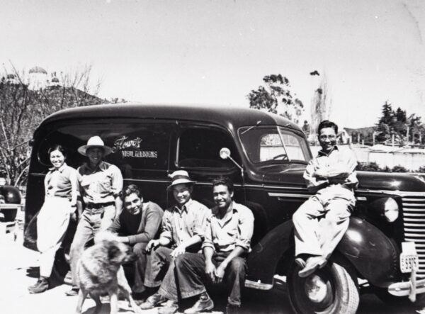 1945: Japanese and Mexican workers gather by a delivery truck for Flower View Gardens.