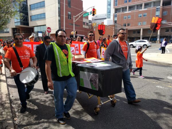 2017: Workers march through New Brunswick with faux coffin, chanting “ni una muerte más.”
